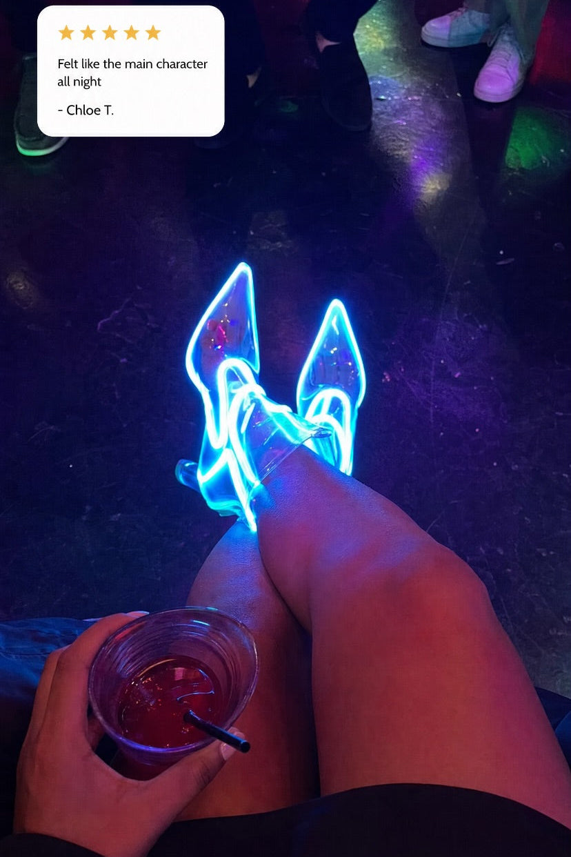 A person wearing glowing blue high Cowboy LED boots at a night club, holding a drink in one hand, with a review text bubble in the top left corner.
