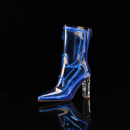 A single transparent knee-high Cowboy LED boots with a pointed toe and clear block heel, shown on a black reflective surface against a black background. The boot has bright blue neon-like outline lighting along its edges.