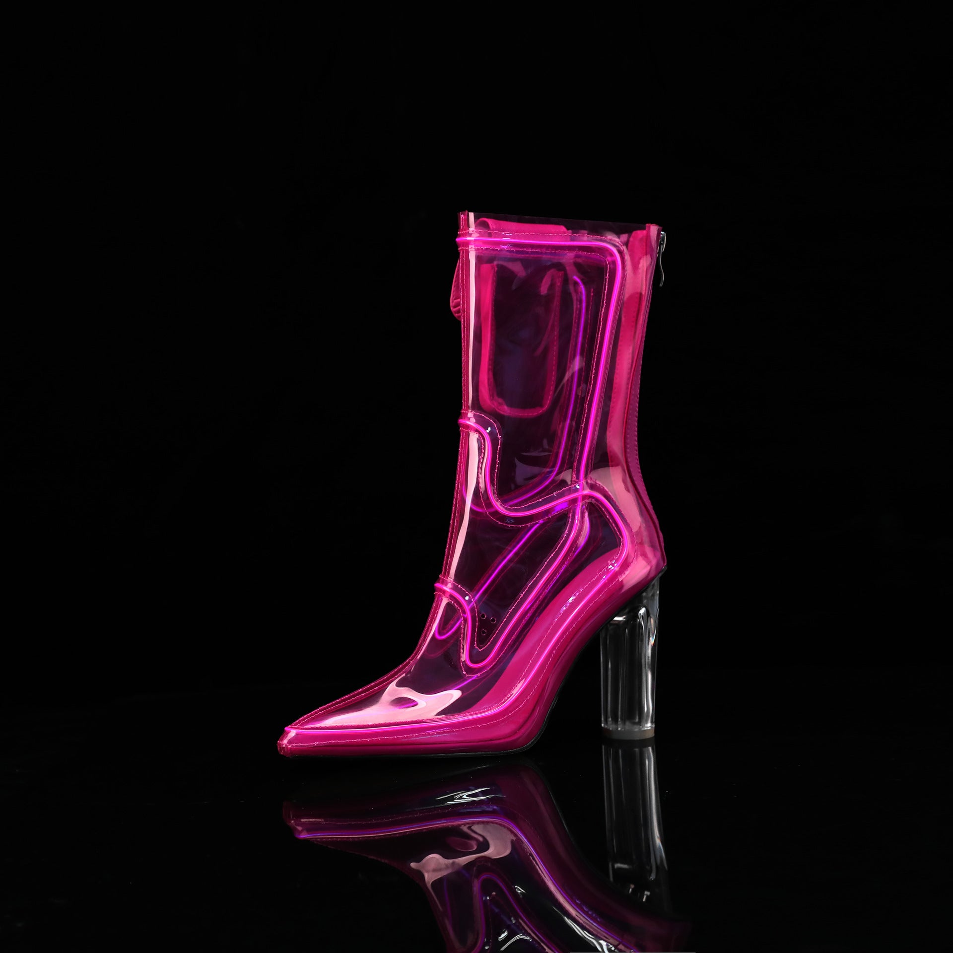 A single transparent pink high-heeled ankle Cowboy LED boots with a clear block heel, photographed on a glossy black reflective surface against a black background.