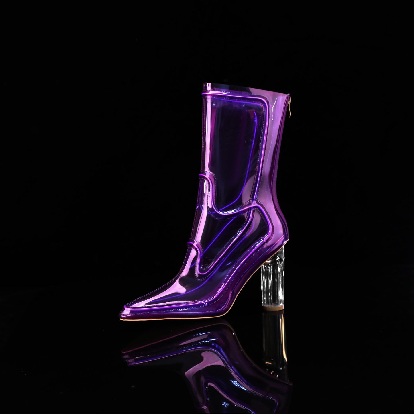 A single glossy translucent purple high-heeled Cowboy LED boots with a clear block heel, photographed on a black reflective surface against a black background.